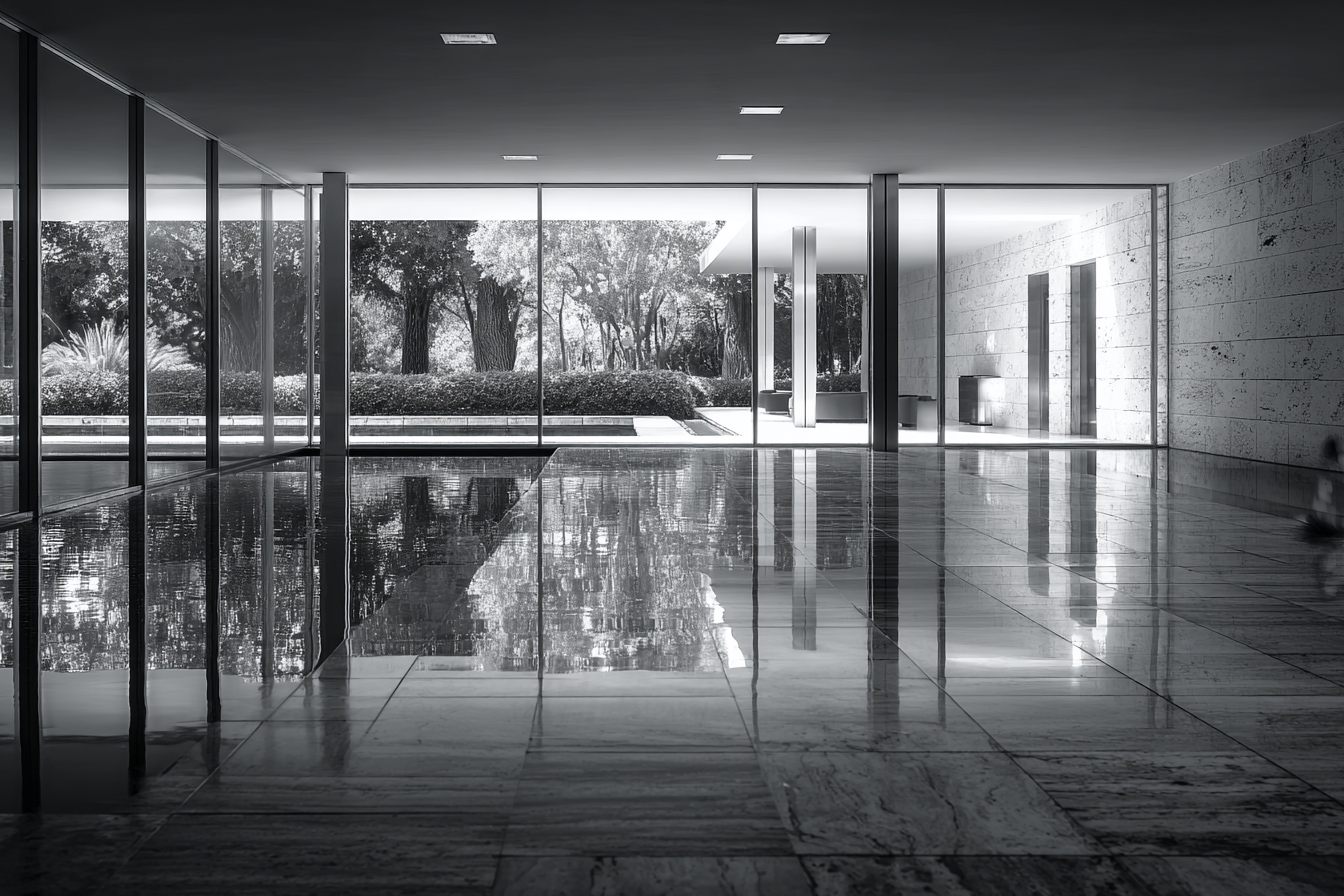 Black and white photograph of Barcelona Pavilion interior with marble floor reflections, precise steel columns, and daylight filtering through glass in minimalist symmetry.