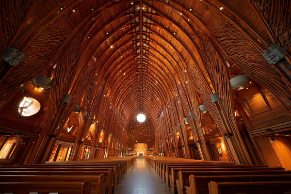 Interior view of St Philip Neri Catholic Church featuring modern basilica style with timber vaults, natural wood detail, and Pietro Belluschi’s architectural vision.